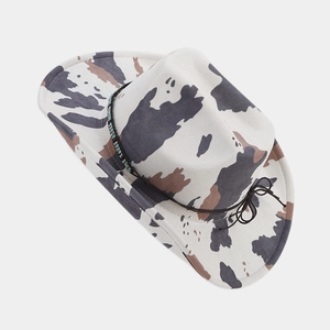 Detail of western cow print fedora with blue beaded band and turquoise stone accents