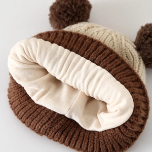 Winter knit baby hat with double pom-poms and warm thick fleece lining in brown
