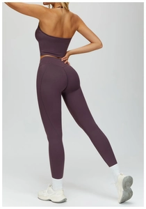 Detail view of high-waisted deep purple yoga pants with V-shaped back seam sculpting