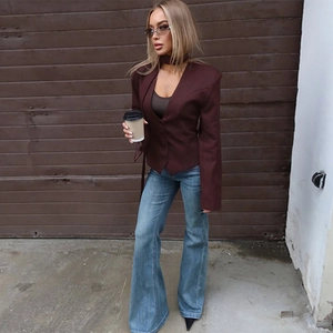 Fashionable dark burgundy slim-fit V-neck blazer paired with high-waist blue flare jeans