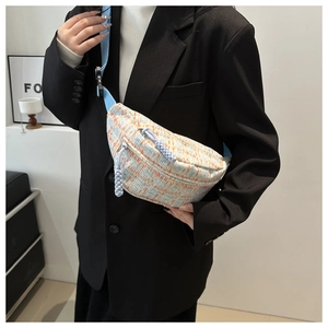 Fashionable light blue and orange textured belt bag with woven zipper and adjustable strap