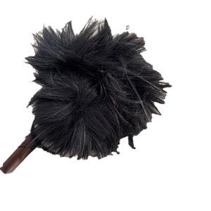 Elegant large black feather scrunchie hair tie with fluffy texture on white background