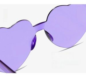Detail of purple heart-shaped sunglasses featuring integrated nose pads for comfort