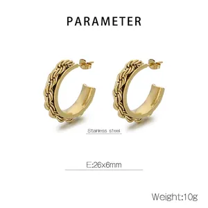Macro view of C-shaped twisted gold earrings in stainless steel with 26x6mm dimensions