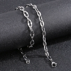 Detailed macro view of silver titanium steel lip chain featuring a secure lobster clasp