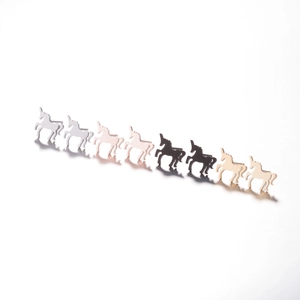 Detailed row of unicorn shaped metal stud earrings in silver, gold, and rose gold finishes