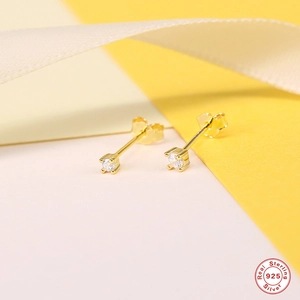 Detail of S925 sterling silver gold-plated stud earrings with a clear round zircon stone