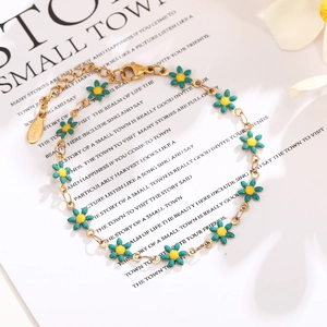 Close-up of golden stainless steel chain with teal daisy charms and adjustable lobster clasp
