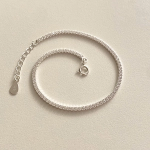 Macro shot of 925 sterling silver tennis bracelet with cubic zirconia and S925 tag