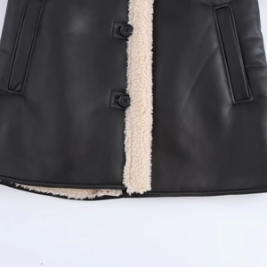Detailed close-up of faux fur lining and buttons on a black faux leather jacket