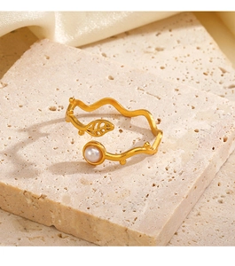 Detail of gold leaf ring with a white pearl on a natural stone and silk display