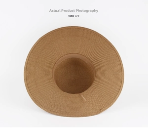 Top view of wide-brim straw sun hat showing interior sweatband and fine woven texture