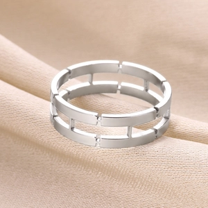 Polished silver stainless steel hollow geometric chain ring on silk background