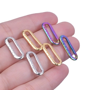 Macro shot of oval 304 stainless steel hoop earrings in silver, gold and rainbow finish