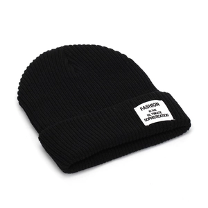 Classic black ribbed knit beanie with stylish white fabric label on the folded cuff