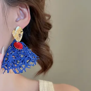 Artistic blue mesh fabric tassel earrings with gold metal studs and red accents