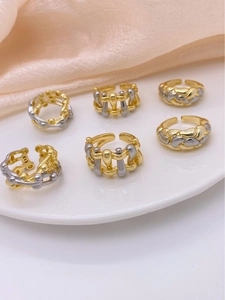 Macro detail of six pieces adjustable woven and geometric rings in gold and silver finish