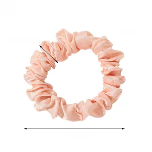 Pink satin scrunchie detail showing smooth silk texture and dimensions of 1.5cm width
