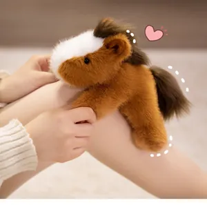 Close-up of soft brown plush horse toy showing fluffy texture and cute white face detail