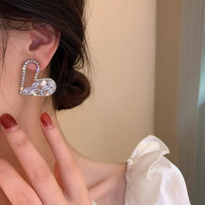 Elegant hollow heart earrings with sparkling cubic zirconia on a model for a chic look