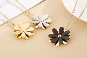 Detailed view of daisy necklaces in gold, silver, and black finish with layered petals