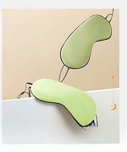 Close-up of double-sided sleep mask with breathable green mesh and smooth silk-like fabric