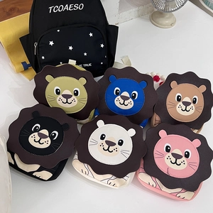Flat lay of colorful cute cartoon lion crossbody bags for children in various colors