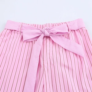 Detailed view of pink striped shorts featuring a matching bow tie waist and elastic band