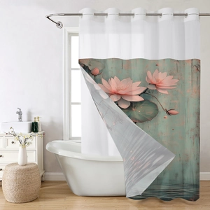 Close-up of waterproof shower curtain with pink lotus flower print and metal grommets