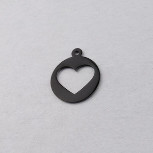 Close-up of black stainless steel hollow heart pendant with small charm for DIY jewelry