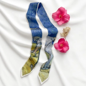 Detailed view of Van Gogh starry night silk ribbon scarf styled with pink flowers