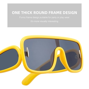 Detail shot of the bold yellow one-piece thick frame and bridge on stylish sunglasses