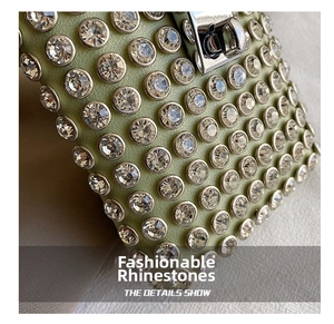 Macro shot of light green leather bag detailing with sparkling rhinestones and silver buckle
