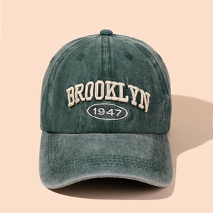 Close-up of vintage dark green baseball cap with Brooklyn 1947 embroidery detail