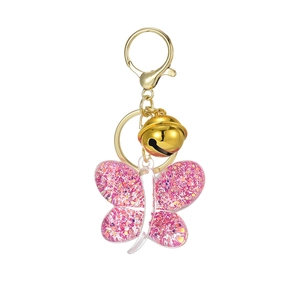 Pink glitter acrylic butterfly keychain with golden metal bell and clasp on white background