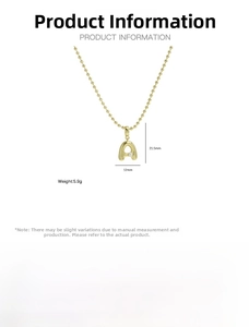 Detail of 18k gold plated brass letter A pendant necklace with pearl inlay and round beads