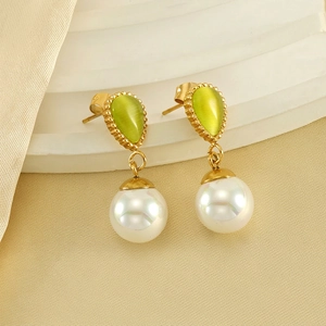 Elegant stainless steel teardrop cat eye stone and pearl earrings on a white stand