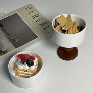 French retro white ceramic pedestal bowls with wooden base shown in a lifestyle food scene