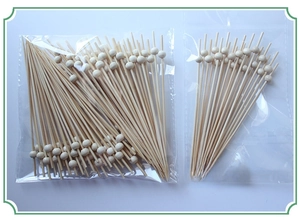 Detail of eco-friendly bamboo skewers with polished wood beads for fruit and appetizers