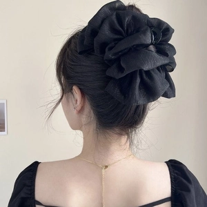 Elegant large black mesh bow hair claw clip for thick hair shown on a model's updo hairstyle