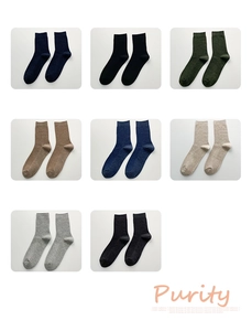 Detail showing eight colors of vertical ribbed cotton business socks in a grid display