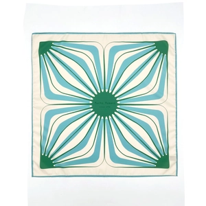 Square silk scarf with geometric star pattern in green, blue, and cream colors