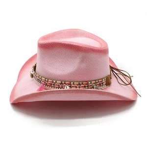 Detail of pink gradient straw cowboy hat with ethnic beads, shells and tassels decoration