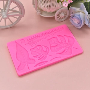 Pink silicone mold featuring tropical leaf textures like monstera for DIY cake decoration