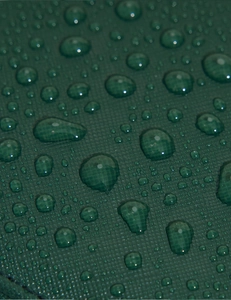 Close-up of green waterproof fabric on jewelry box showing water droplets