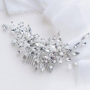 Detail of bridal hair comb with crystal rhinestones and white pearls on silver wire