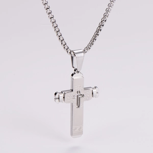 Detail of silver stainless steel cross pendant with Greek fret patterns and box chain