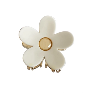 Elegant white flower hair claw clip with golden accents on a clean white background