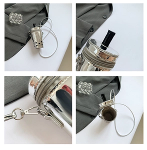 Detail view of silver milk tea cup bag with metallic finish, zipper, and metal hardware