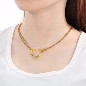 Golden heart pendant necklace with rhinestones and double woven chain on model